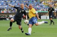 MUNICH, GERMANY - JUNE 18:  Ronaldo of Brazil has a shot on goal as Craig Moore of Australia tries to block during the FIFA World Cup Germany 2006 Group F match between Brazil and  Australia at the Stadium Munich on June 18, 2006 in Munich, Germany.  (Photo by Phil Cole/Getty Images)